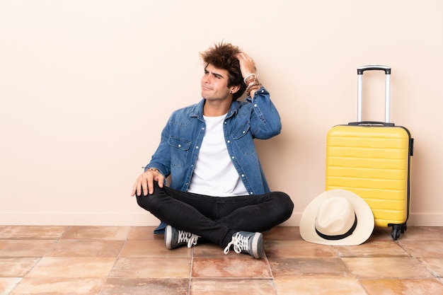 Traveler man sitting on the floor