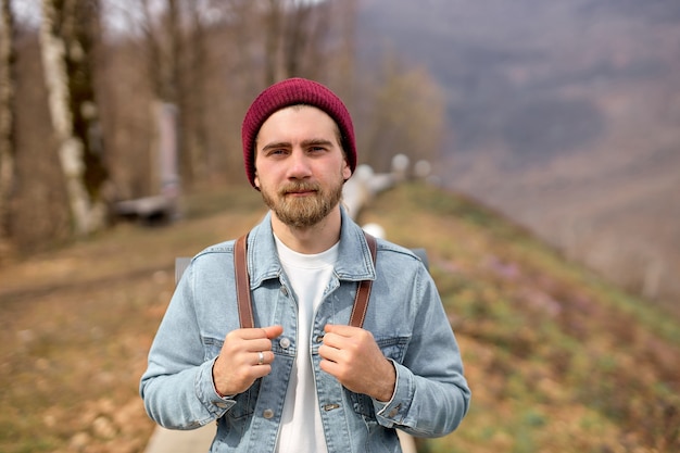 Traveler man with backpack walking alone in nature. Freedom concept. Copy space