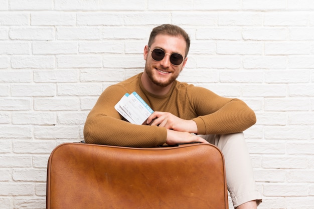 Traveler man with suitcase and boarding pass