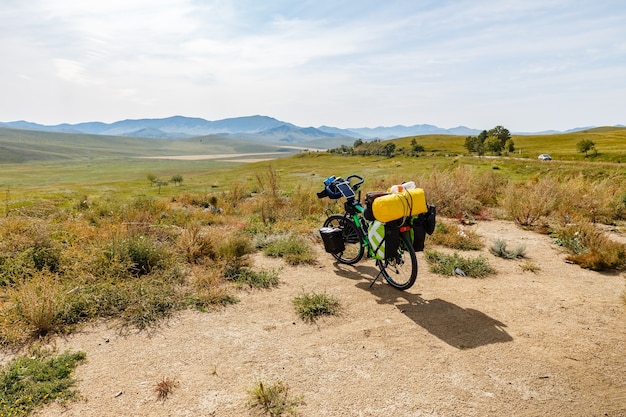 Traveler's bike with bags, landscape in mongolia, Bike adventure travel, tourist bike