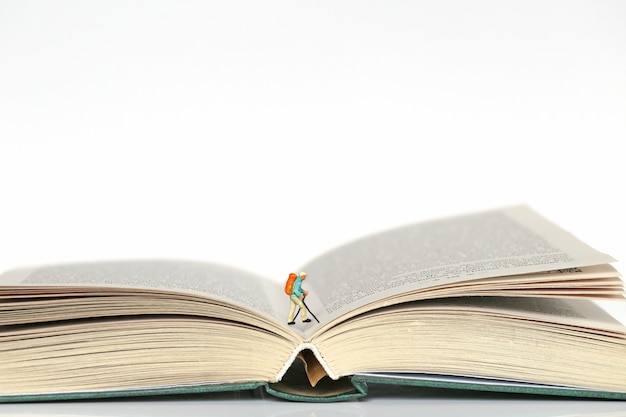 Traveler's figure on the pages of books on a white background