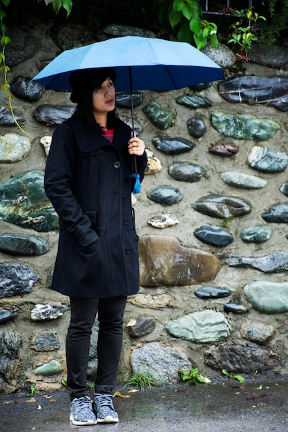 Traveler thai women holding umbrella and walking on the road of resort Pfunds city in morning time and raining in Tyrol Austria