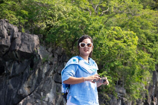 Traveler thai women people travel visit and usr smart mobile
phone take photo between local trip tour travel visit ko khao yai
and prasat hin pan yod and san lang mangkorn at la ngu in satun
thailand