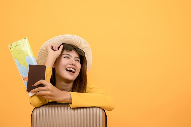 Traveler tourist woman in summer casual clothes isolated over yellow background