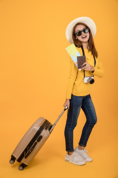 Traveler tourist woman in summer casual clothes isolated over yellow background