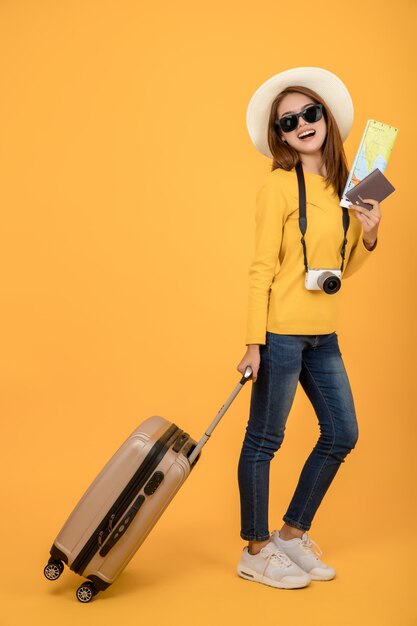 Traveler tourist woman in summer casual clothes isolated over yellow background