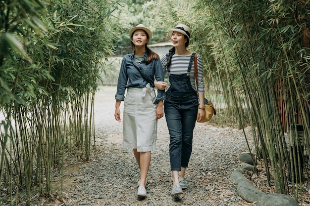 Traveler walk together arm in arm in Bamboo Grove