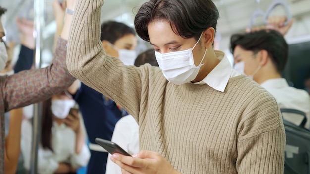 Traveler wearing face mask while using mobile