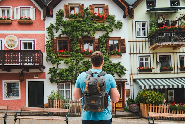 Traveler with backpack at central city square in hallstatt