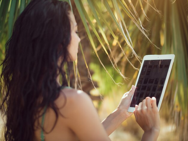 Traveler woman using tablet computer.