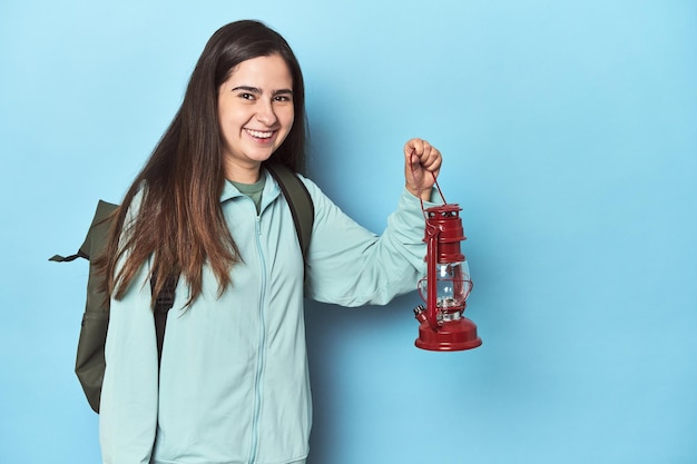 Traveler woman with backpack and hand lamp ready for adventure