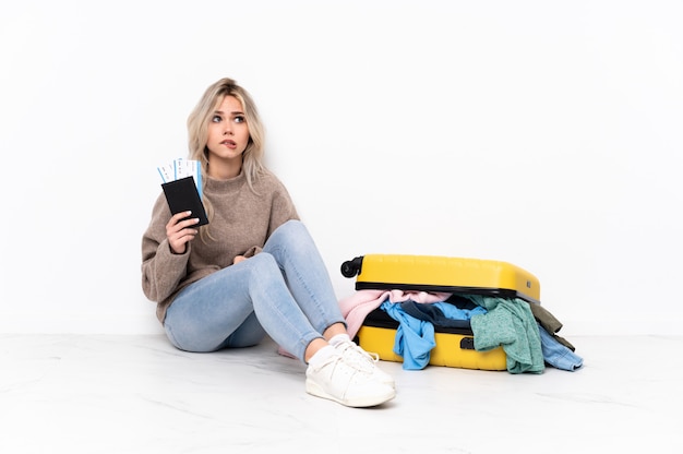 Traveler woman with a suitcase full of clothes