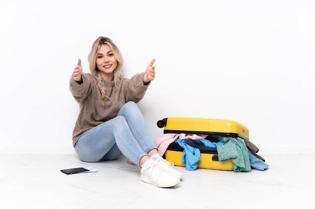 Traveler woman with a suitcase full of clothes