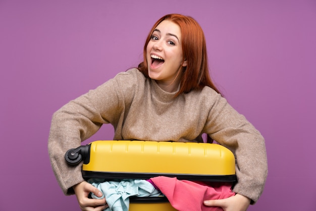 Traveler woman with a suitcase full of clothes