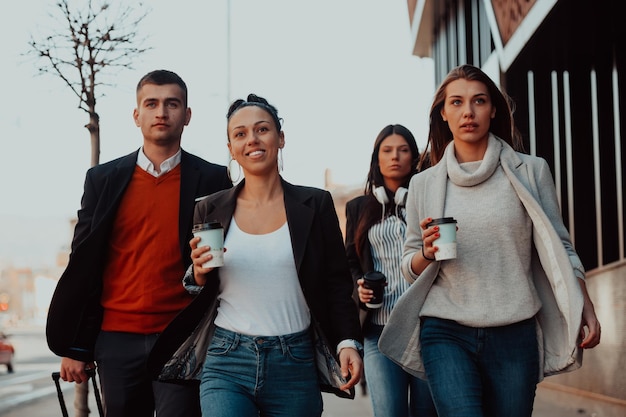 Travelers business team of colleagues walking and talking on modern urban city streets. People on out of the office on break. High quality photo