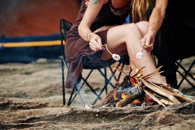 Travelers frying marshmallows