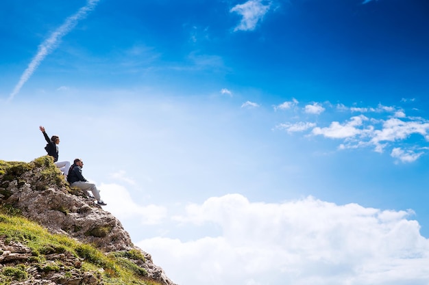 Travelers hikers on top of a mountain enjoying valley view Travel Holidays Freedom Concept