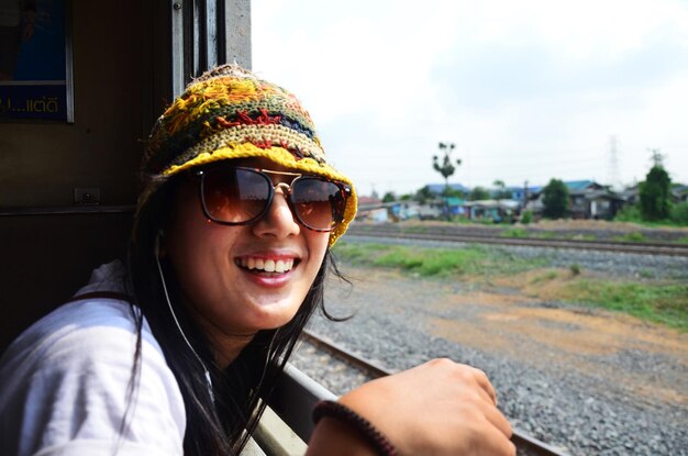 Travelers thai women people sitting on railway for journey explorer and portrait posing for take photo at window train go to destination travel visit Phra Nakhon si Ayutthaya from Bangkok Thailand