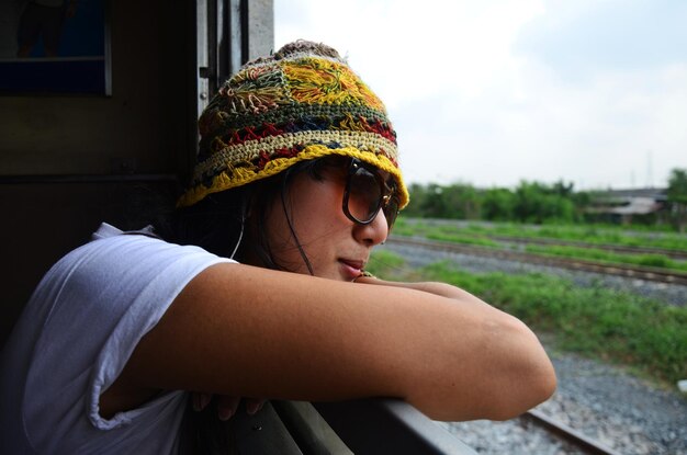 Travelers thai women people sitting on railway for journey explorer and portrait posing on train