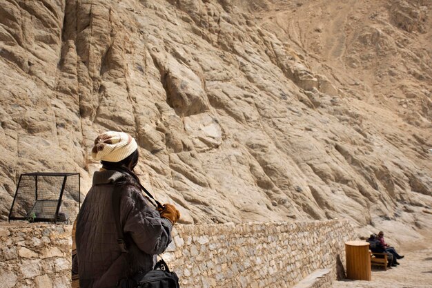 Travelers thai women people travel visit and take photo view landscape of Leh Ladakh Village from viewpoint of Leh Stok Palace at Jammu and Kashmir India in winter season