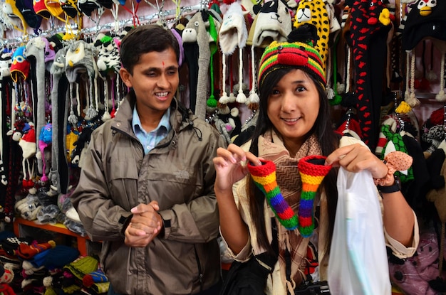 Travelers thai women visit buy products and posing portrait with nepali people vendor in souvenirs gifts local shop at street bazaar market at thamel old town on October 29 2013 in Kathmandu Nepal