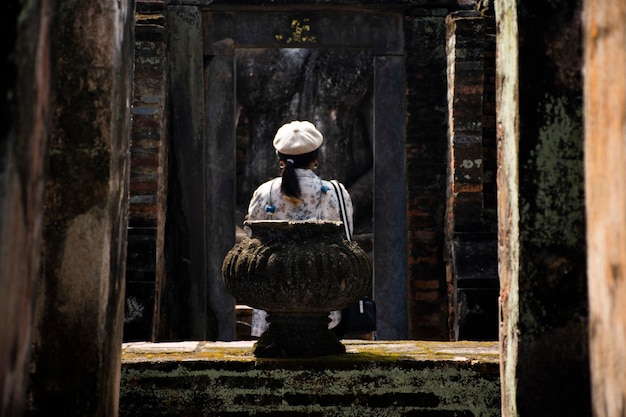 Travelerthai women people journey travel visit and shooting take photo ancient ruins of Wat Si Chum