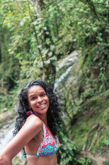 Traveling girl in swimsuit by the river. Vacation and Tourism Concept