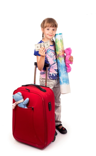 Traveling with children Tourism Cute little girl and big red suitcase isolated on white background