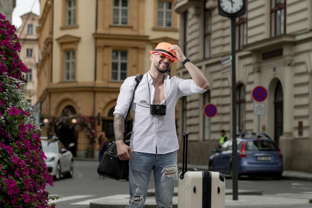 Traveller fashion tourist traveler tourist man in casual clothes hat with suitcase tourist man with