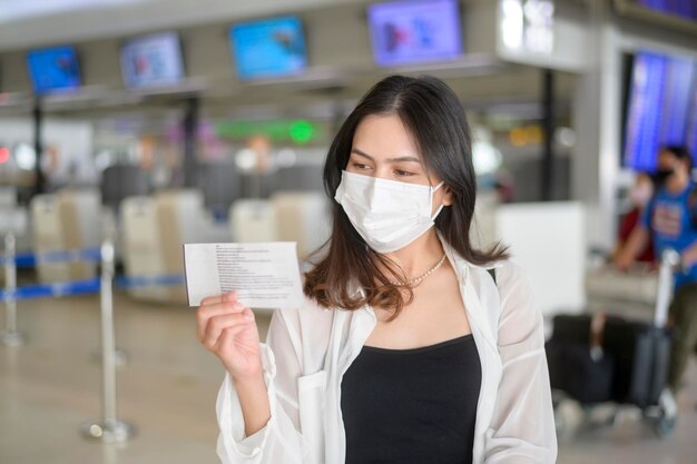 A traveller woman is wearing protective mask in International airport