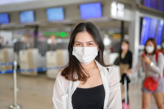 A traveller woman is wearing protective mask in International airport