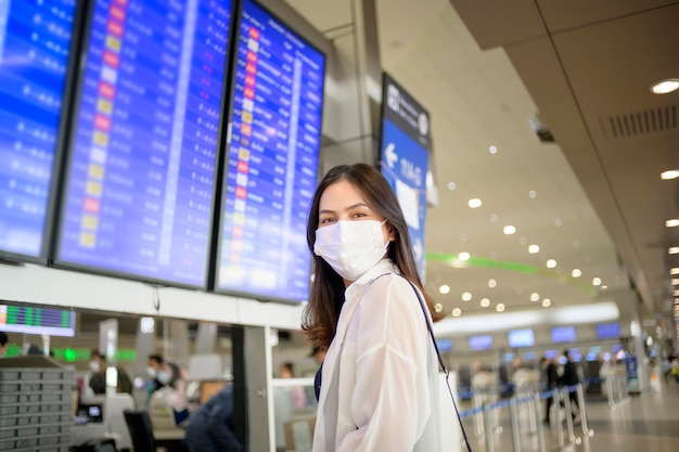 A traveller woman is wearing protective mask in International airport