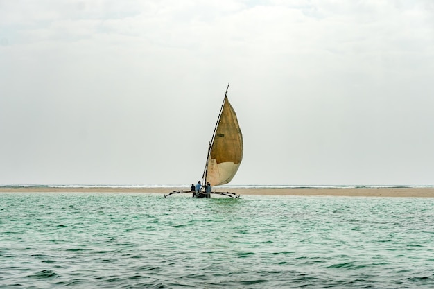 travelling Africa Kenya and Zanzibar seascape with crystal clear turquoise water and traditional sail boat landscape from Diani Beach