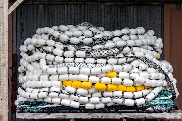 Trawler fishing net and floats stored on wooden pallet