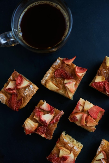 백그라운드에서 커피 한 잔과 사과 shortbread 사각형의 트레이.