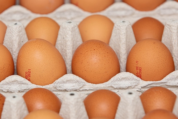 Tray of brown and organic chicken eggs on the table