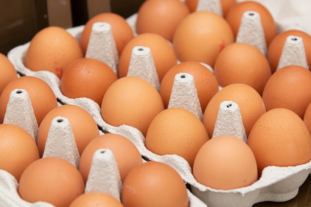 Tray of brown and organic chicken eggs on the table