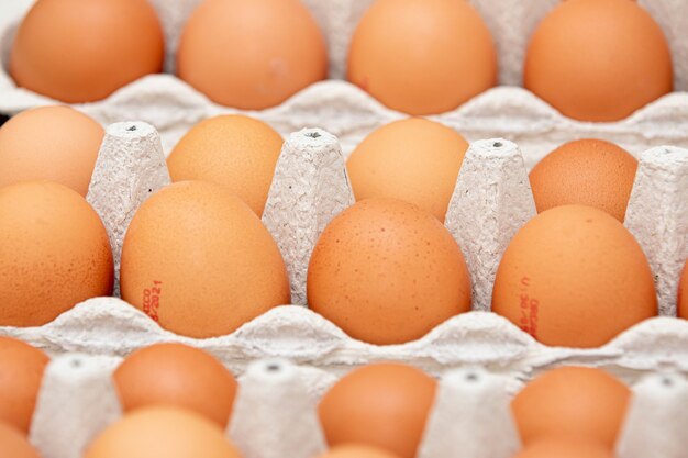 Tray of brown and organic chicken eggs on the table