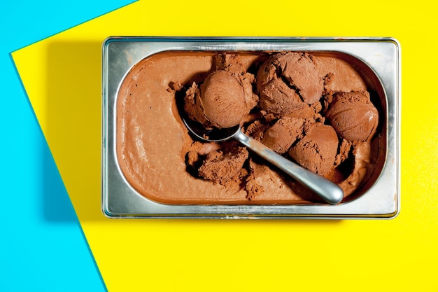 A tray of chocolate ice cream with a spoon in it