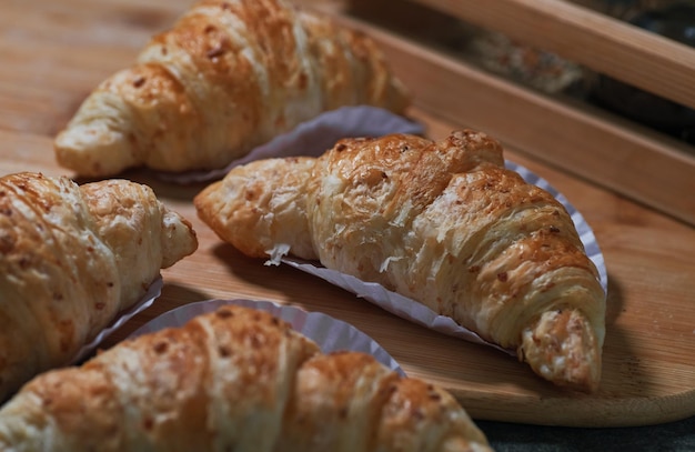 A tray of croissants on a wooden board