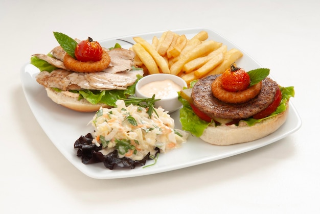 a tray of food including a sandwich french fries and a salad