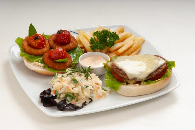 a tray of food including a sandwich fries and a salad