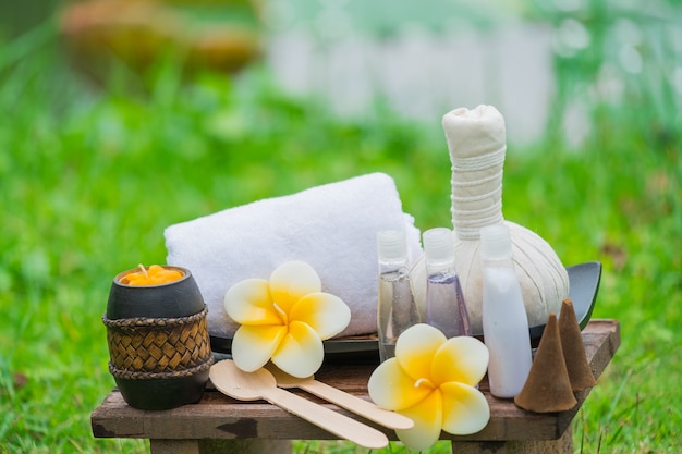 tray of spa products over green reeds on river