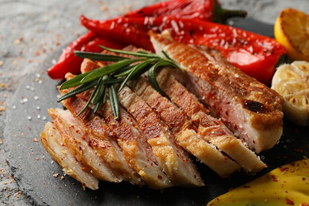 Tray with chopped pork steak and vegetables. Grilled food