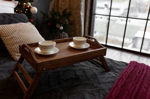 tray with coffee cups. breakfast in bed. bedside table