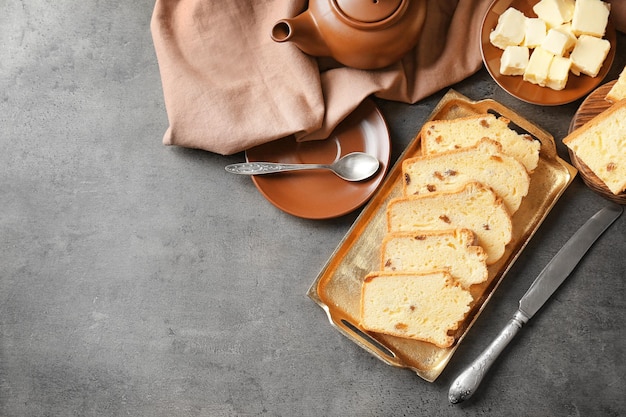 Photo tray with delicious sliced butter cake on table