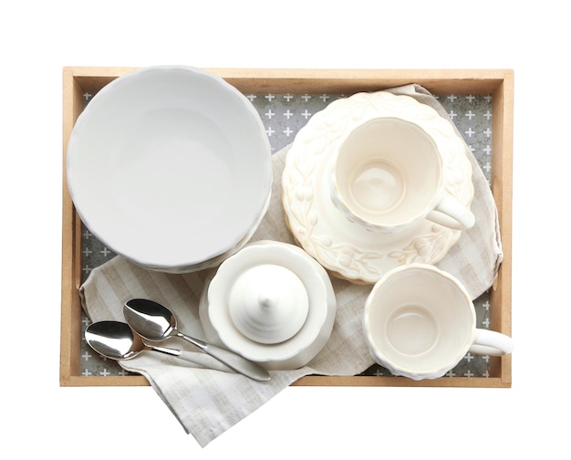 Фото Поднос с различными посудой на белом фоне