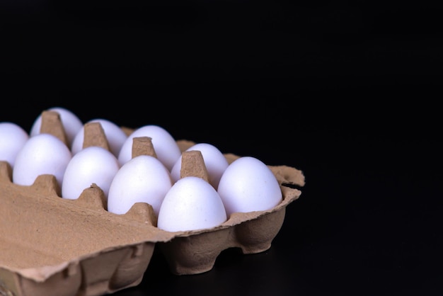 A tray with eggs on a black background. Protein diet, Fletley. Keto.