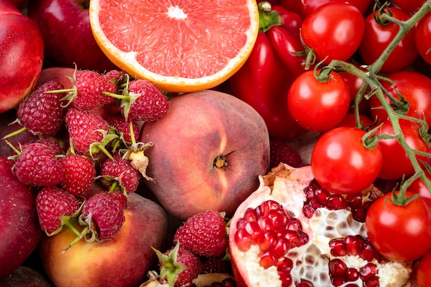 Tray with fresh red vegetables and fruits Healthy eating vegetarian concept.