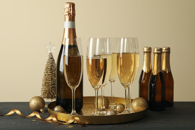 Tray with glasses and bottle of champagne